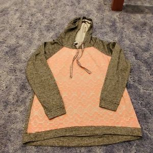 Gray and peach colored sweat shirt